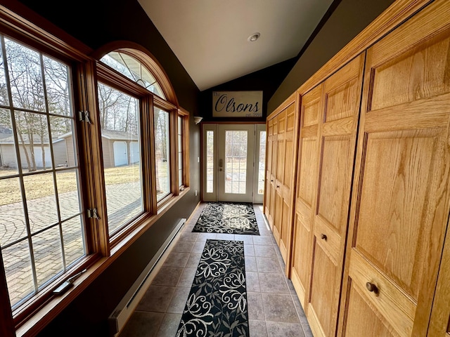 entryway featuring lofted ceiling, tile patterned floors, and a baseboard radiator