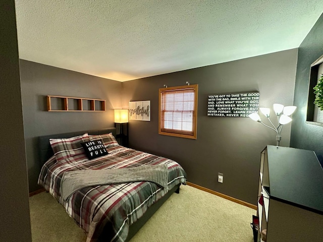 bedroom with baseboards, a textured ceiling, and carpet
