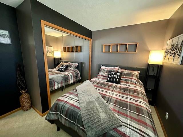 bedroom with baseboards, carpet flooring, and a closet