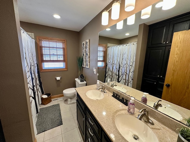 bathroom with tile patterned floors, visible vents, and a sink