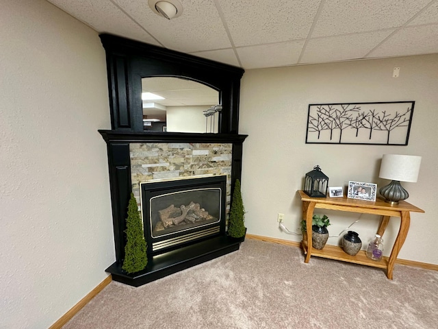 details featuring baseboards, carpet flooring, and a large fireplace