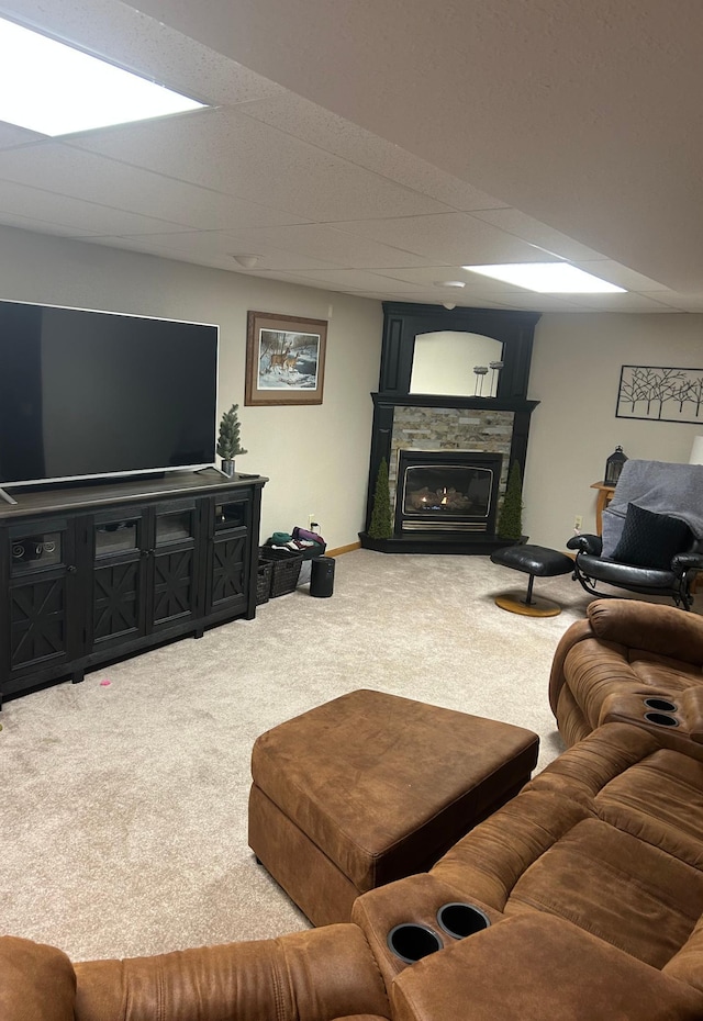 carpeted living room with baseboards and a glass covered fireplace
