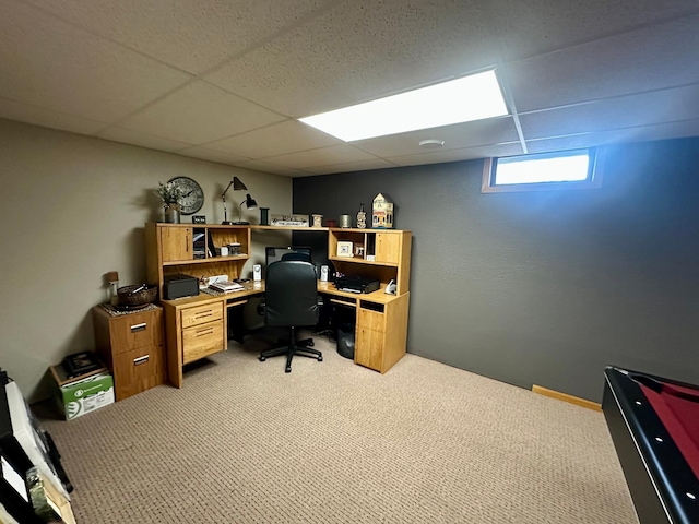 office space featuring a drop ceiling and light carpet