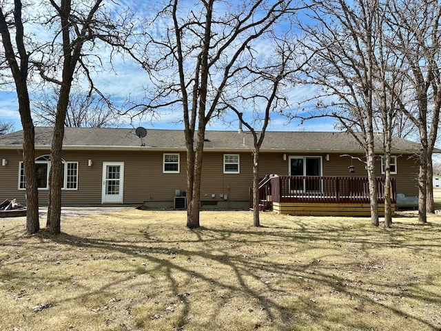 back of property with central AC and a wooden deck