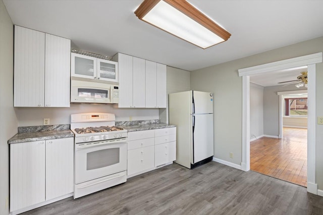 kitchen with white cabinetry, light wood-style flooring, ceiling fan, light countertops, and white appliances