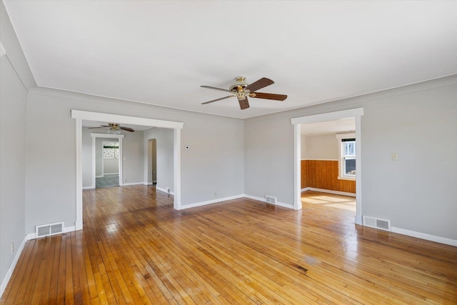 unfurnished room featuring visible vents, ceiling fan, and light wood-style flooring