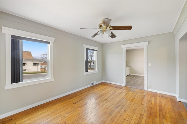 unfurnished bedroom featuring baseboards, light wood-type flooring, visible vents, and ceiling fan