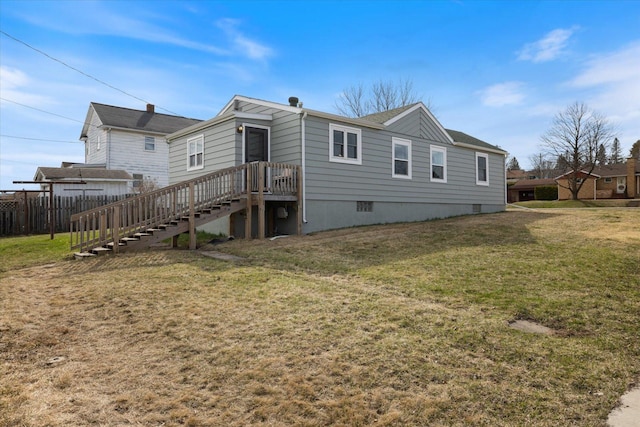 back of house with a yard and fence