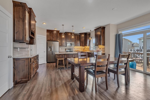 dining area featuring recessed lighting and dark wood finished floors