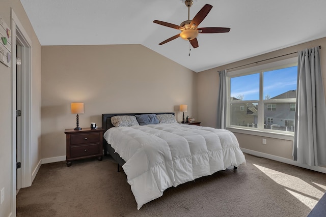 carpeted bedroom featuring lofted ceiling, baseboards, and ceiling fan