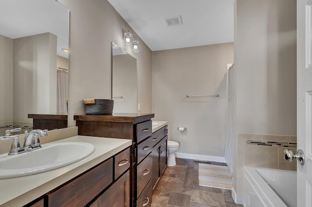 bathroom with toilet, a bath, vanity, baseboards, and visible vents