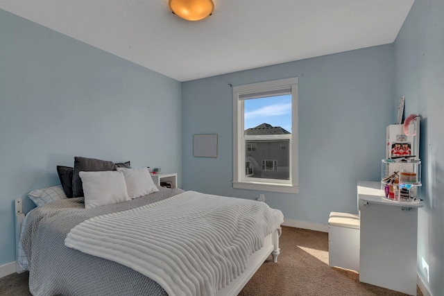 bedroom with baseboards and carpet