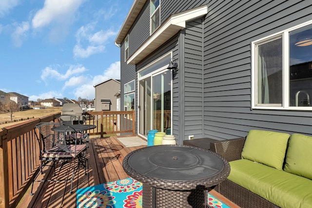 wooden terrace featuring outdoor lounge area and a residential view