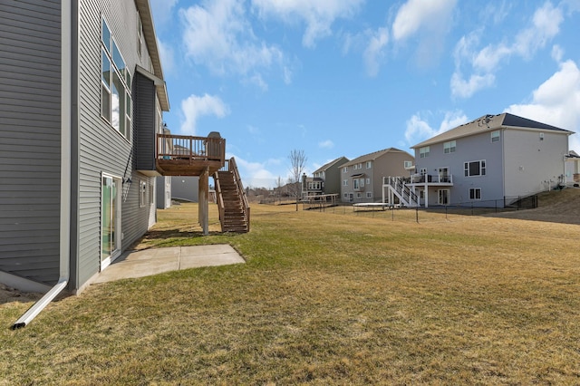 view of yard featuring stairway, fence, a residential view, a patio, and a deck