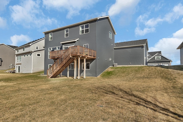 back of property featuring stairway, a lawn, and a deck