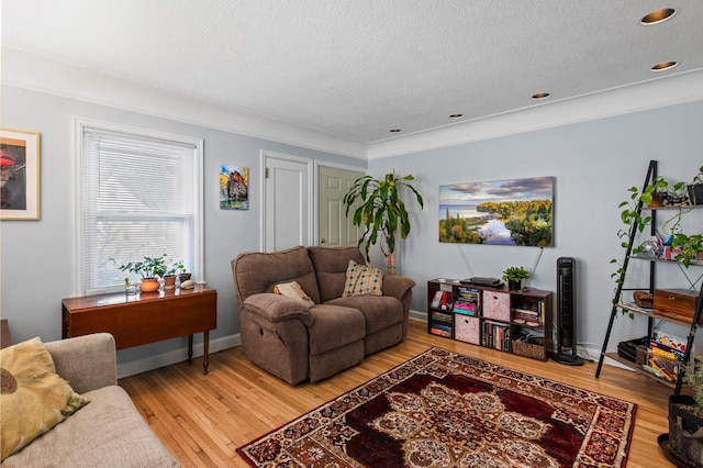 living room featuring light wood-type flooring, recessed lighting, and a textured ceiling