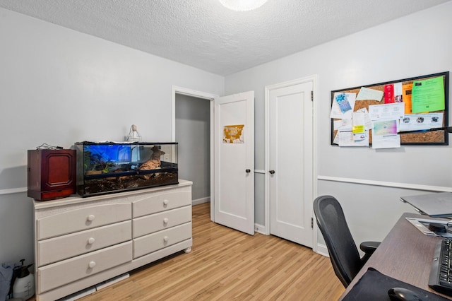 office area featuring a textured ceiling and light wood-style floors