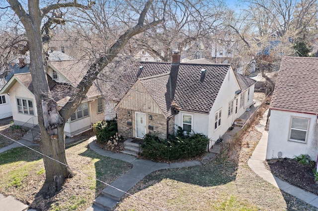 46324634 Cedar Ave S, Minneapolis, MN 55407 - view of front facade with roof with shingles, a chimney, and stucco siding