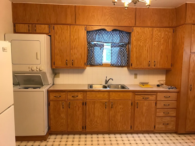 1509 5th St, Mankato, MN 56001 - kitchen featuring stacked washer / dryer, light floors, light countertops, a sink, and freestanding refrigerator