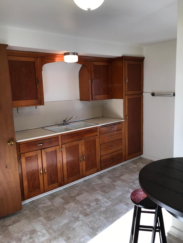 1509 5th St, Mankato, MN 56001 - kitchen with brown cabinets, a sink, and light countertops