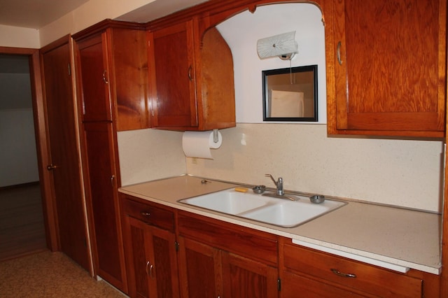 1509 5th St, Mankato, MN 56001 - kitchen with light countertops, arched walkways, brown cabinetry, and a sink