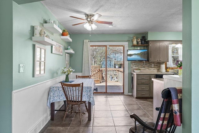 kitchen featuring visible vents, open shelves, light countertops, a textured ceiling, and a ceiling fan