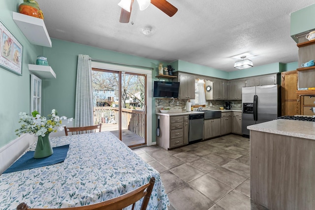 kitchen with ceiling fan, backsplash, open shelves, light countertops, and stainless steel appliances