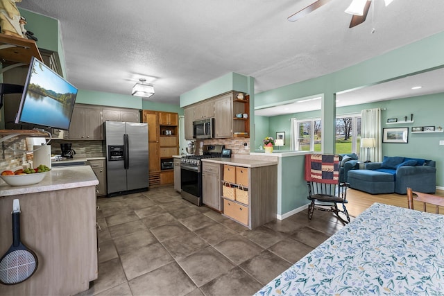kitchen featuring light countertops, stainless steel appliances, open shelves, and tasteful backsplash