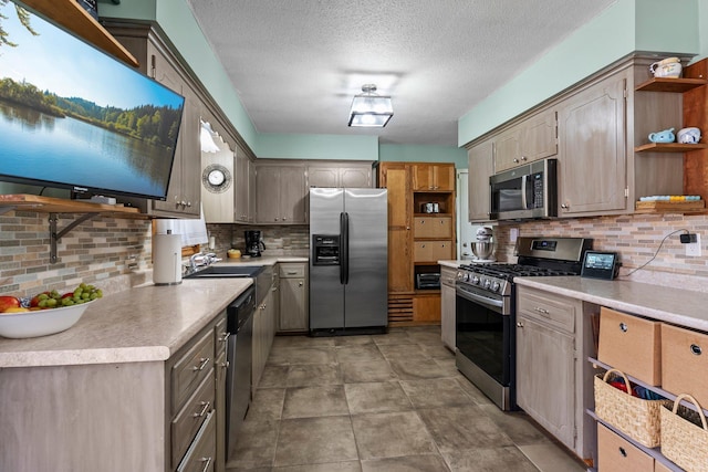 kitchen with decorative backsplash, a textured ceiling, appliances with stainless steel finishes, open shelves, and light countertops