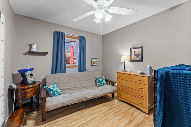 living area featuring ceiling fan and light wood-type flooring