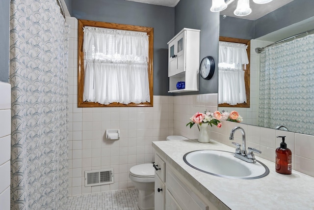 bathroom featuring a shower with curtain, visible vents, tile walls, vanity, and toilet