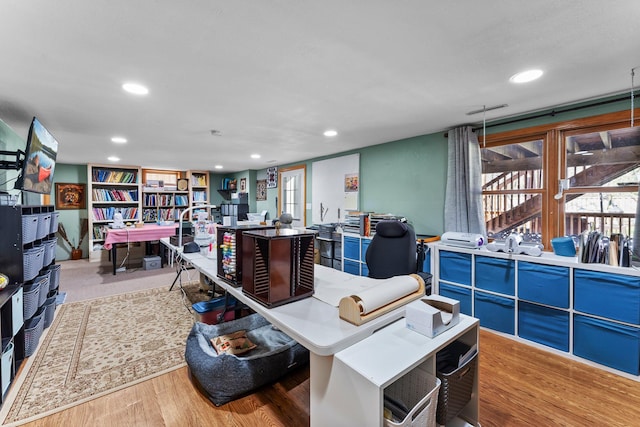 miscellaneous room featuring recessed lighting and wood finished floors