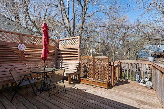 wooden terrace featuring outdoor dining space