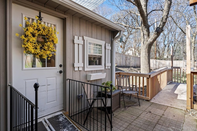 entrance to property with fence and a wooden deck