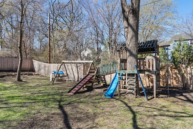 view of play area with a lawn and fence