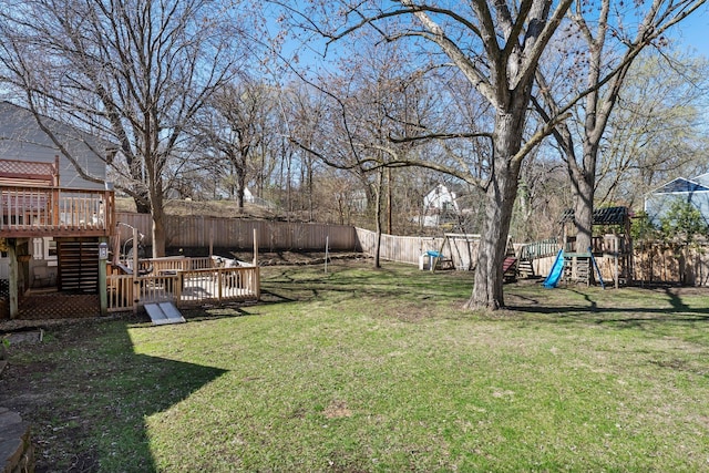 view of yard with stairway, a wooden deck, a fenced backyard, and a playground