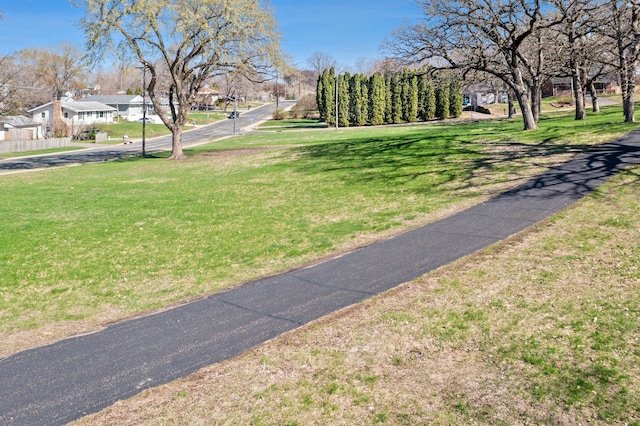 view of home's community with a yard and a residential view