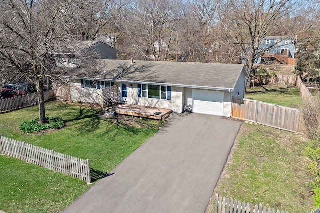 single story home featuring fence, a garage, a wooden deck, a front yard, and driveway