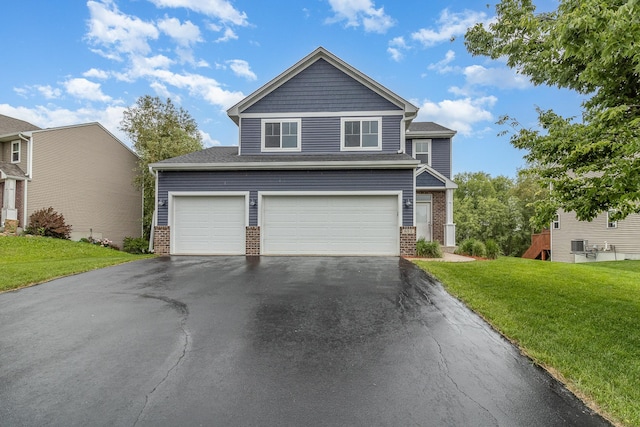 657 Golden Oak St NE, Lonsdale, MN 55046 - view of front of property featuring brick siding, asphalt driveway, a front yard, and a garage