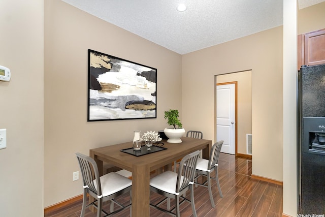 657 Golden Oak St NE, Lonsdale, MN 55046 - dining room with dark wood-style flooring and a textured ceiling