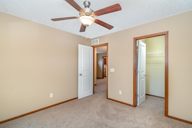 657 Golden Oak St NE, Lonsdale, MN 55046 - unfurnished bedroom with light carpet, a spacious closet, a closet, and a ceiling fan