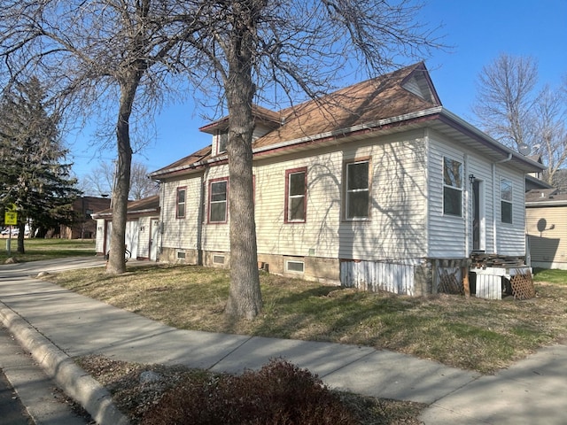 view of property exterior with a lawn
