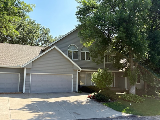 11943 Orchard Ave W, Minnetonka, MN 55305 - view of front facade featuring driveway, an attached garage, and roof with shingles