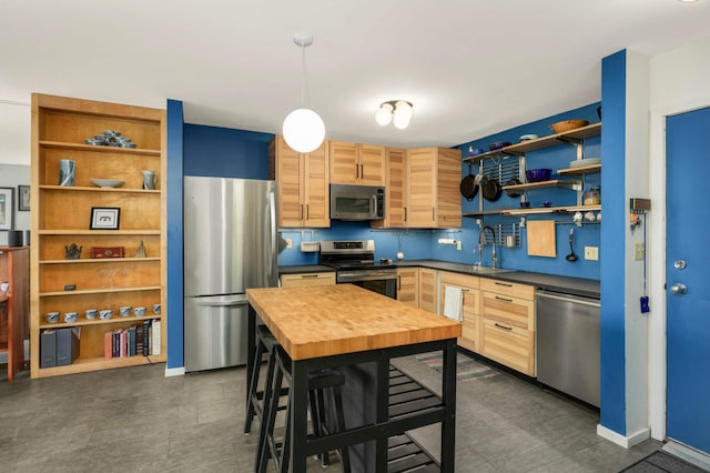 121 Washington Ave S Unit 1508, Minneapolis, MN 55401 - kitchen featuring appliances with stainless steel finishes, open shelves, pendant lighting, a sink, and butcher block counters