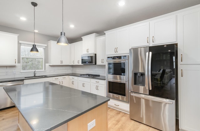 3088 Sunflower Way NW, Prior Lake, MN 55352 - kitchen with stainless steel appliances, a sink, backsplash, dark countertops, and recessed lighting