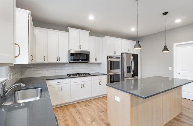3088 Sunflower Way NW, Prior Lake, MN 55352 - kitchen featuring stainless steel appliances, a sink, light wood finished floors, white cabinets, and tasteful backsplash