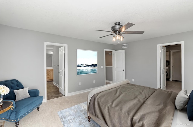 3088 Sunflower Way NW, Prior Lake, MN 55352 - carpeted bedroom featuring baseboards, connected bathroom, and a ceiling fan