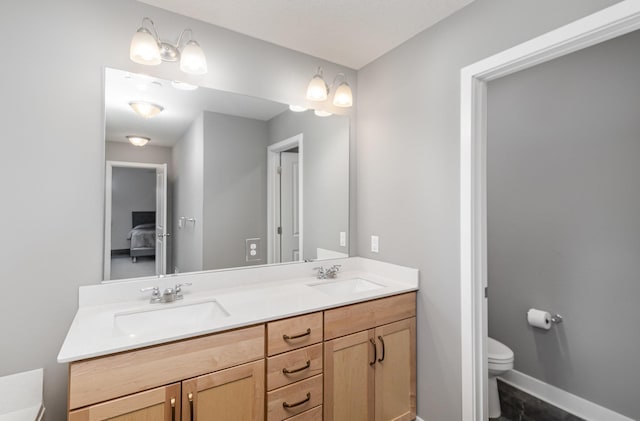 3088 Sunflower Way NW, Prior Lake, MN 55352 - bathroom with toilet, double vanity, ensuite bath, and baseboards