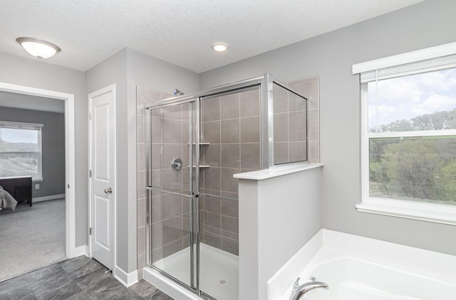 3088 Sunflower Way NW, Prior Lake, MN 55352 - ensuite bathroom featuring a shower stall, healthy amount of natural light, and a textured ceiling