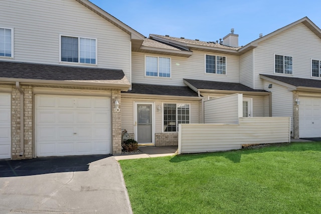 multi unit property featuring a chimney, fence, a shingled roof, and a front lawn
